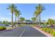 Inviting clubhouse entrance lined with mature palm trees and meticulously maintained landscaping at 1991 High Mesa Dr, Henderson, NV 89012