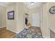 Welcoming entryway with wood floors, coat rack, decorative rug and adjacent hallway at 1991 High Mesa Dr, Henderson, NV 89012