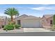 Charming single-story home features a two-car garage, desert landscaping, and a well-manicured lawn at 1991 High Mesa Dr, Henderson, NV 89012