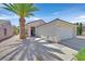 Single-story house has a two-car garage, desert landscaping, and sidewalk leading to front door at 1991 High Mesa Dr, Henderson, NV 89012