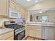 Well-lit kitchen with stainless steel appliances, wooden cabinets, and modern countertop at 1991 High Mesa Dr, Henderson, NV 89012