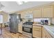Well-equipped kitchen with stainless steel appliances, wooden cabinets, and modern fixtures at 1991 High Mesa Dr, Henderson, NV 89012