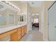 Bright main bathroom featuring tile floors, walk-in shower, and a vanity with ample counter space at 1991 High Mesa Dr, Henderson, NV 89012
