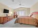 Bright main bedroom with bay window, ceiling fan, plush carpet, and stylish furnishings at 1991 High Mesa Dr, Henderson, NV 89012