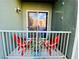 Cozy balcony with red chairs, small table, and relaxing outdoor space at 20 E Serene Ave # 111, Las Vegas, NV 89123