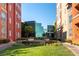 Well-manicured community grounds with grass and modern glass building at 20 E Serene Ave # 111, Las Vegas, NV 89123