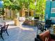 An outdoor kitchen featuring built-in BBQ grills and stone countertops, ideal for outdoor cooking and entertaining at 20 E Serene Ave # 111, Las Vegas, NV 89123