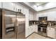 Modern kitchen featuring stainless steel appliances, granite countertops, and ample white cabinetry at 20 E Serene Ave # 111, Las Vegas, NV 89123