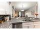 Open concept: kitchen with granite countertops, tile backsplash, and stainless steel appliances at 20 E Serene Ave # 111, Las Vegas, NV 89123