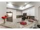 Bright kitchen featuring white cabinets, granite counters and backsplash, and stainless appliances at 20 E Serene Ave # 111, Las Vegas, NV 89123