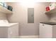 Functional laundry area equipped with a washer, dryer, and shelving for easy organization and storage at 20 E Serene Ave # 111, Las Vegas, NV 89123