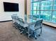 Bright meeting room with glass table, ergonomic chairs, and large windows providing natural light at 20 E Serene Ave # 111, Las Vegas, NV 89123