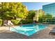 Sparkling swimming pool surrounded by lounge chairs and lush greenery at 20 E Serene Ave # 111, Las Vegas, NV 89123