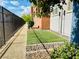 Small turf yard between condos with rock landscaping and metal fence at 20 E Serene Ave # 111, Las Vegas, NV 89123