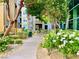Picturesque walkway with lush landscaping, manicured bushes, and a view of the building at 20 E Serene Ave # 111, Las Vegas, NV 89123