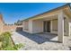 Backyard patio area with pavers, partial covering and view of rear exterior at 2110 Albury Ave, North Las Vegas, NV 89086