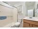 Bathroom featuring a shower, toilet, vanity, and mirrored cabinet at 2110 Albury Ave, North Las Vegas, NV 89086