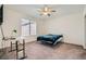 Cozy bedroom with a ceiling fan, carpet floors, white walls, and natural light from the window at 2110 Albury Ave, North Las Vegas, NV 89086