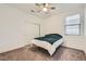 Comfortable bedroom with neutral carpet, ceiling fan, window, and closet at 2110 Albury Ave, North Las Vegas, NV 89086