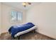 Cozy bedroom with a ceiling fan, window with blinds, and neutral carpet at 2110 Albury Ave, North Las Vegas, NV 89086