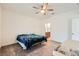 Clean bedroom with carpeted floors, ceiling fan, and view of bathroom at 2110 Albury Ave, North Las Vegas, NV 89086