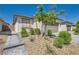 Inviting single-story home with desert landscaping, hardscape, and a two-car garage at 2110 Albury Ave, North Las Vegas, NV 89086