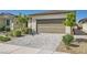 Single-story home with a desert landscape and paver driveway at 2110 Albury Ave, North Las Vegas, NV 89086