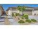 Single-story home featuring desert landscaping, pavers, and a two-car garage at 2110 Albury Ave, North Las Vegas, NV 89086