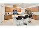 Bright kitchen with stainless steel appliances, light wood cabinets, white countertops and a center island with seating at 2110 Albury Ave, North Las Vegas, NV 89086