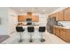 Bright open kitchen features an island with bar seating, stainless steel appliances, and stylish cabinets at 2110 Albury Ave, North Las Vegas, NV 89086