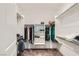 Spacious walk-in closet with white shelving, hanging rods, and carpet floors at 2110 Albury Ave, North Las Vegas, NV 89086