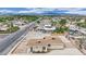 This is an aerial shot of the neighborhood showing the house, the yard, other houses, the mountains, and the sky at 2200 Stanley Ave, North Las Vegas, NV 89030