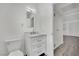 Bathroom with vanity featuring marble countertops, soft-close drawers, and updated fixtures at 2200 Stanley Ave, North Las Vegas, NV 89030