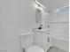 A bathroom showcases a white toilet, vanity, mirror and subway tile shower at 2200 Stanley Ave, North Las Vegas, NV 89030