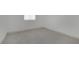 A vacant bedroom features neutral walls, gray tile flooring, and a window with blinds at 2200 Stanley Ave, North Las Vegas, NV 89030