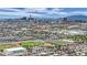 This is an aerial shot of the city showing other houses, buildings, trees, sports fields, and the sky at 2200 Stanley Ave, North Las Vegas, NV 89030
