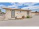 Beige home exterior featuring security bars on the windows with concrete walkway at 2200 Stanley Ave, North Las Vegas, NV 89030