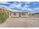 Exterior view of home featuring barred windows and minimal landscaping at 2200 Stanley Ave, North Las Vegas, NV 89030