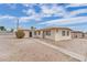 Beige house with security bars on the windows with a front yard at 2200 Stanley Ave, North Las Vegas, NV 89030