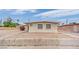 Beige home with front yard, security bars on windows, and clear blue sky overhead at 2200 Stanley Ave, North Las Vegas, NV 89030