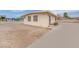 Side view of home with security bars on windows and front concrete driveway at 2200 Stanley Ave, North Las Vegas, NV 89030