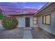 Charming single story house featuring a secure black gate entry and vibrant front foliage at 2200 Stanley Ave, North Las Vegas, NV 89030