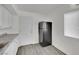 Kitchen with a black fridge, white cabinets, and modern vinyl flooring at 2200 Stanley Ave, North Las Vegas, NV 89030