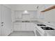 This kitchen features white cabinets, stainless steel sink, white appliances, and light countertops at 2200 Stanley Ave, North Las Vegas, NV 89030