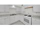 Well-lit kitchen featuring white cabinets, stone countertops, and modern cooking appliances at 2200 Stanley Ave, North Las Vegas, NV 89030
