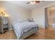 Comfortable bedroom featuring wood floors, ceiling fan, and ensuite bathroom for easy living at 2325 Windmill Pkwy # 323, Henderson, NV 89074