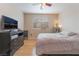 Bright bedroom boasts a large window, wood floors, and a television for relaxation at 2325 Windmill Pkwy # 323, Henderson, NV 89074