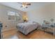 Cozy bedroom with wood-look floors, natural light, and simple stylish decor at 2325 Windmill Pkwy # 323, Henderson, NV 89074