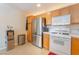 Functional kitchen features stainless steel refrigerator and range, white countertops and light wood cabinets at 2325 Windmill Pkwy # 323, Henderson, NV 89074