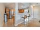 Well-lit kitchen with stainless steel appliances and breakfast bar seating with decorative chairs at 2325 Windmill Pkwy # 323, Henderson, NV 89074